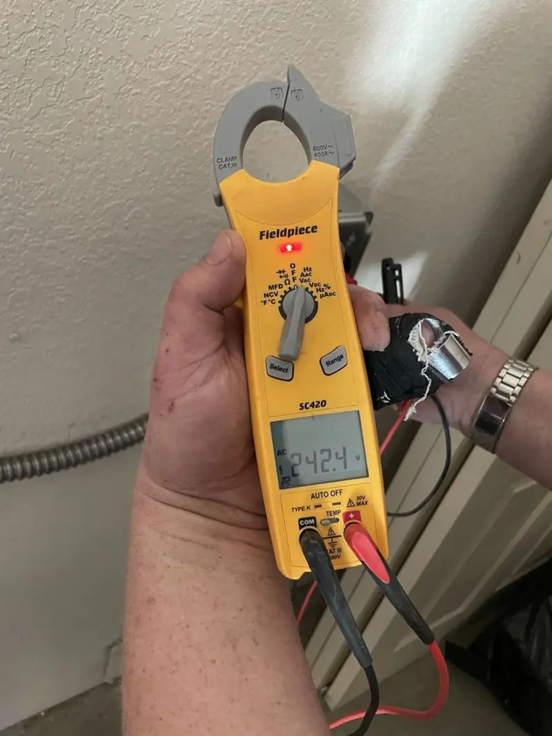 Voltage testing with clamp meter during Ceiling Fan Installation in Wenatchee